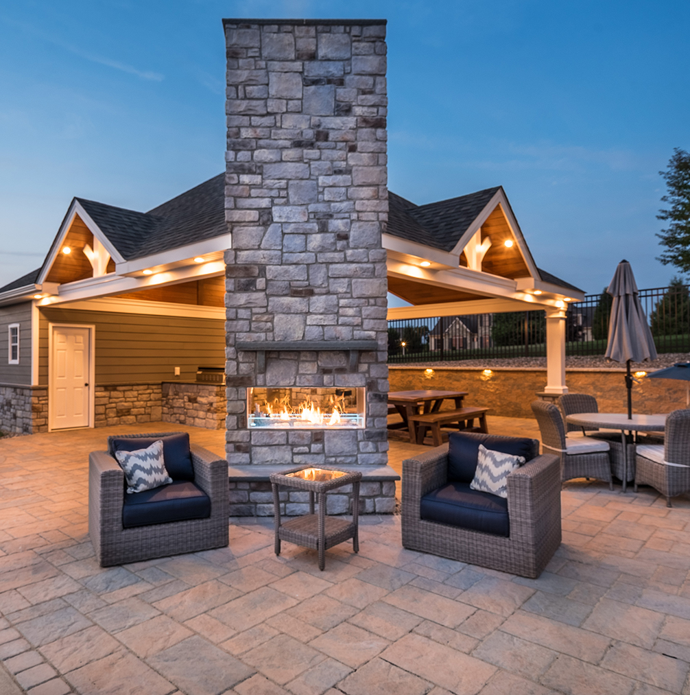 fireplace, outdoor seating and pavilion in back